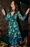 Contrasting green and blue florals decorate the base of this elegant silhouette, completed with velvet trims. The plunge neckline and full sleeves make this the perfect transitional Autumn piece, whilst the button front adds an extra detail. With a shirred back panel for ease of wear, the Babette is a perfect seasonal staple for any event.