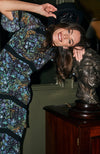Hand-designed ditsy florals bloom across the dark base in powerful blue, green and orange tones. With tiered skirt and bell sleeves, this figure hugging pencil midi style dress is undeniably flattering. Finished with lace trims, dress up or down for the perfect transitional piece this Autumn.