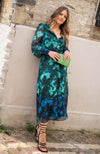 Contrasting green and blue florals decorate the base of this elegant silhouette, completed with velvet trims. The plunge neckline and full sleeves make this the perfect transitional Autumn piece, whilst the button front adds an extra detail. With a shirred back panel for ease of wear, the Babette is a perfect seasonal staple for any event.