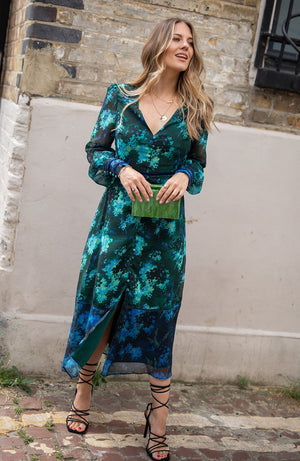 Contrasting green and blue florals decorate the base of this elegant silhouette, completed with velvet trims. The plunge neckline and full sleeves make this the perfect transitional Autumn piece, whilst the button front adds an extra detail. With a shirred back panel for ease of wear, the Babette is a perfect seasonal staple for any event.