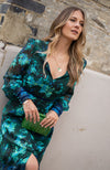 Contrasting green and blue florals decorate the base of this elegant silhouette, completed with velvet trims. The plunge neckline and full sleeves make this the perfect transitional Autumn piece, whilst the button front adds an extra detail. With a shirred back panel for ease of wear, the Babette is a perfect seasonal staple for any event.