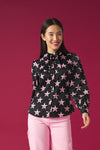 Long puff sleeve blouse. Collar and optional bow tie detail. Front button fastening.