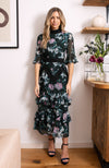 Hand-designed soft florals brush the green base in soft blues and pinks. The high cut neckline boasts statement lace trim that also covers the waist and skirt. Style down with ankle boots for day-to-day looks, or style up with heels for dressy occa