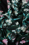 Hand-designed soft florals brush the green base in soft blues and pinks. The high cut neckline boasts statement lace trim that also covers the waist and skirt. Style down with ankle boots for day-to-day looks, or style up with heels for dressy occa