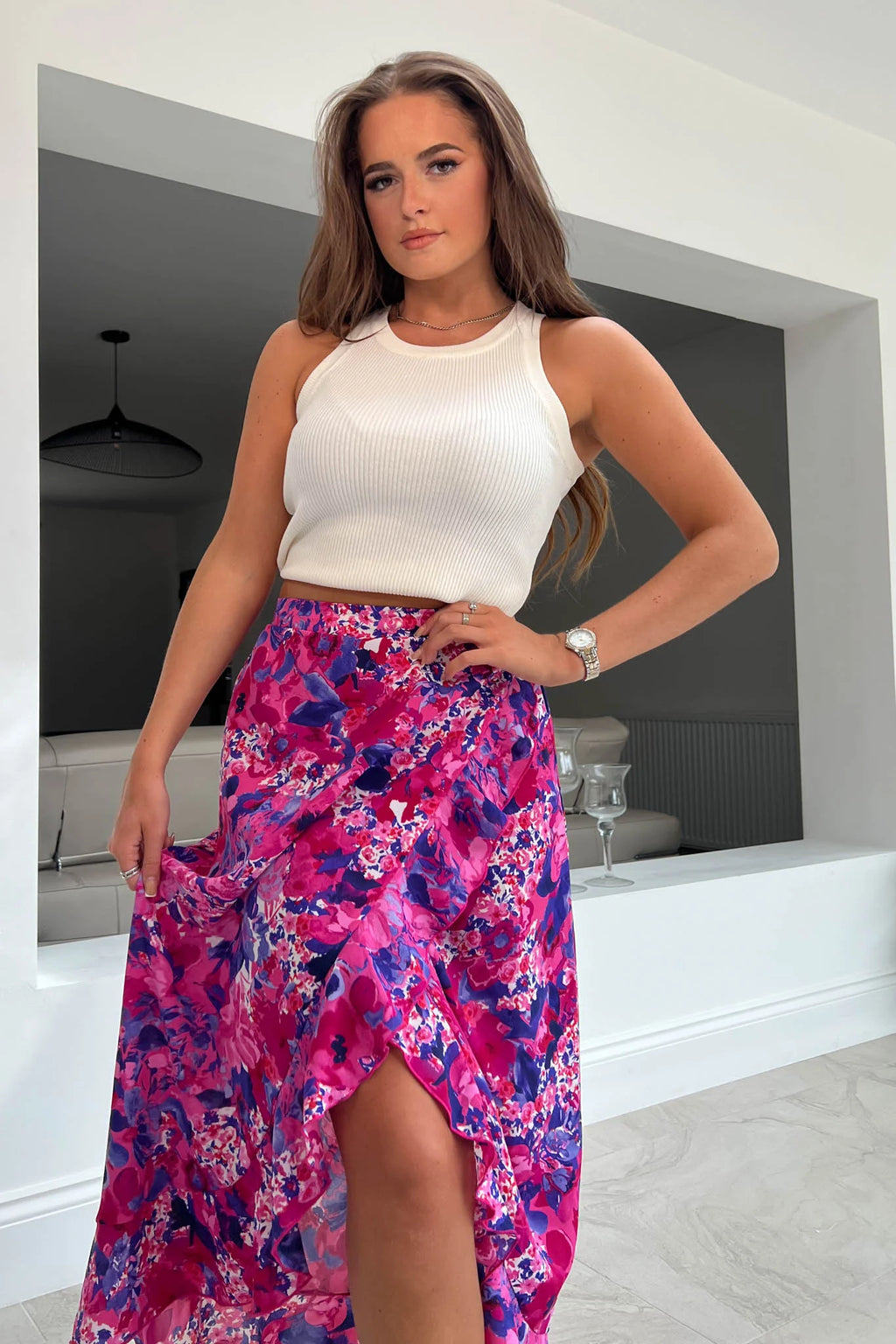 Featuring a frilled hem, wrap detailing and a thick figure skimming waistband. Pair with trainers and a high neck body for a glam casual look. 