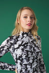 Midi dress with turtleneck. Long sleeves. Gathering detail. Back button fastening.