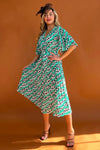 Featuring a wrap over neckline &amp; delicate pleated angel sleeves, this midi dress cinches you in at the waist with a large belt with buckle detail creating the perfect silhouette. The invisible zip fastening is perfect for easy on and the pleated midi skirt creates a soft &amp; feminine vibe.