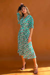 Featuring a wrap over neckline &amp; delicate pleated angel sleeves, this midi dress cinches you in at the waist with a large belt with buckle detail creating the perfect silhouette. The invisible zip fastening is perfect for easy on and the pleated midi skirt creates a soft &amp; feminine vibe.