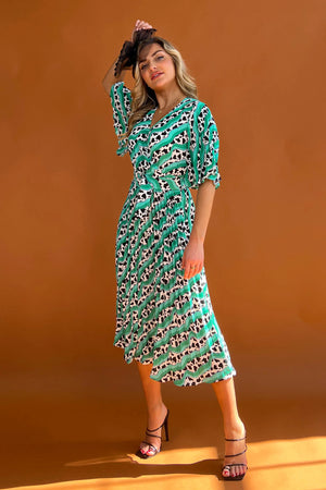 Featuring a wrap over neckline &amp; delicate pleated angel sleeves, this midi dress cinches you in at the waist with a large belt with buckle detail creating the perfect silhouette. The invisible zip fastening is perfect for easy on and the pleated midi skirt creates a soft &amp; feminine vibe.