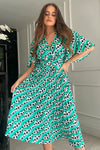 Featuring a wrap over neckline &amp; delicate pleated angel sleeves, this midi dress cinches you in at the waist with a large belt with buckle detail creating the perfect silhouette. The invisible zip fastening is perfect for easy on and the pleated midi skirt creates a soft &amp; feminine vibe.