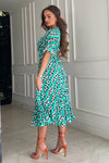 Featuring a wrap over neckline &amp; delicate pleated angel sleeves, this midi dress cinches you in at the waist with a large belt with buckle detail creating the perfect silhouette. The invisible zip fastening is perfect for easy on and the pleated midi skirt creates a soft &amp; feminine vibe.