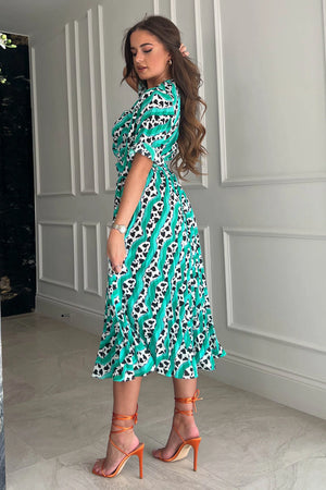 Featuring a wrap over neckline &amp; delicate pleated angel sleeves, this midi dress cinches you in at the waist with a large belt with buckle detail creating the perfect silhouette. The invisible zip fastening is perfect for easy on and the pleated midi skirt creates a soft &amp; feminine vibe.