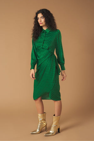 Long sleeve shirt dress. Wrap skirt. Ruffle detail on the skirt. Front button fastening and side zip.