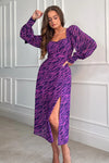 Featuring a sweetheart neckline, long sleeves, cinched in waist and a side slit. Pair with heels for a night out and boots for a casual event 