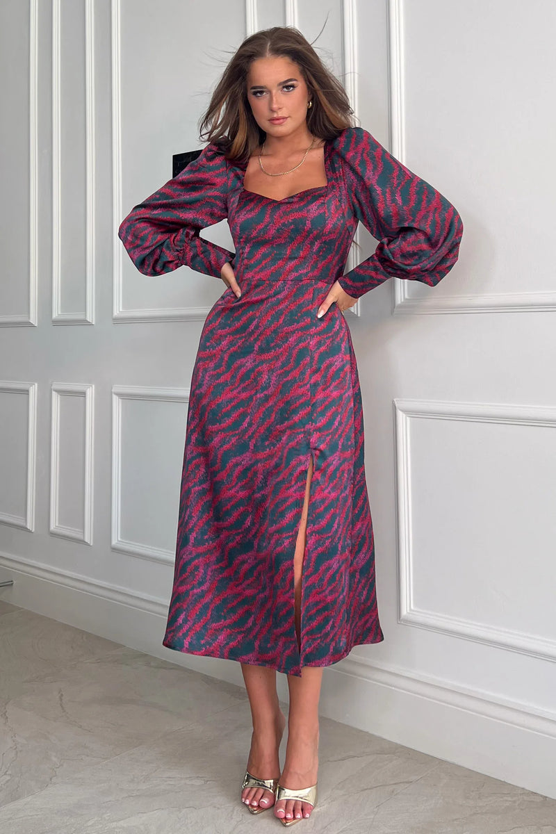 Add a bold print to your wardrobe with our beautiful Katie Sweetheart Long Sleeve Midi Dress. Featuring a sweetheart neckline, long sleeves, cinched in waist and a side slit. Pair with heels for a night out and boots for a casual event.