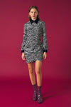 Collar dress with long sleeves and cuffs with button. Skirt with draped detail and wrap front. Back zip fastening.