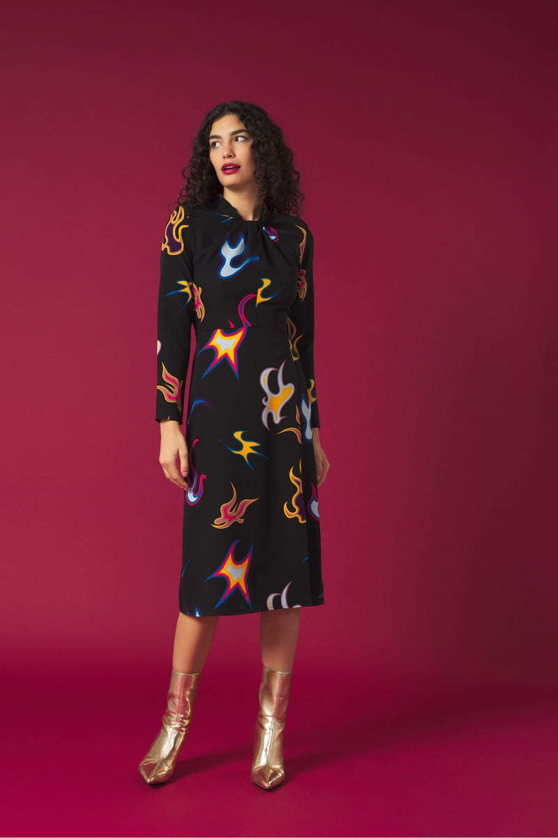 Round neck dress with long sleeves. Front knot detail. Front vent. Back zip fastening.