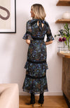 Hand-designed ditsy florals bloom across the dark base in powerful blue, green and orange tones. With tiered skirt and bell sleeves, this figure hugging pencil midi style dress is undeniably flattering. Finished with lace trims, dress up or down for the perfect transitional piece this Autumn.