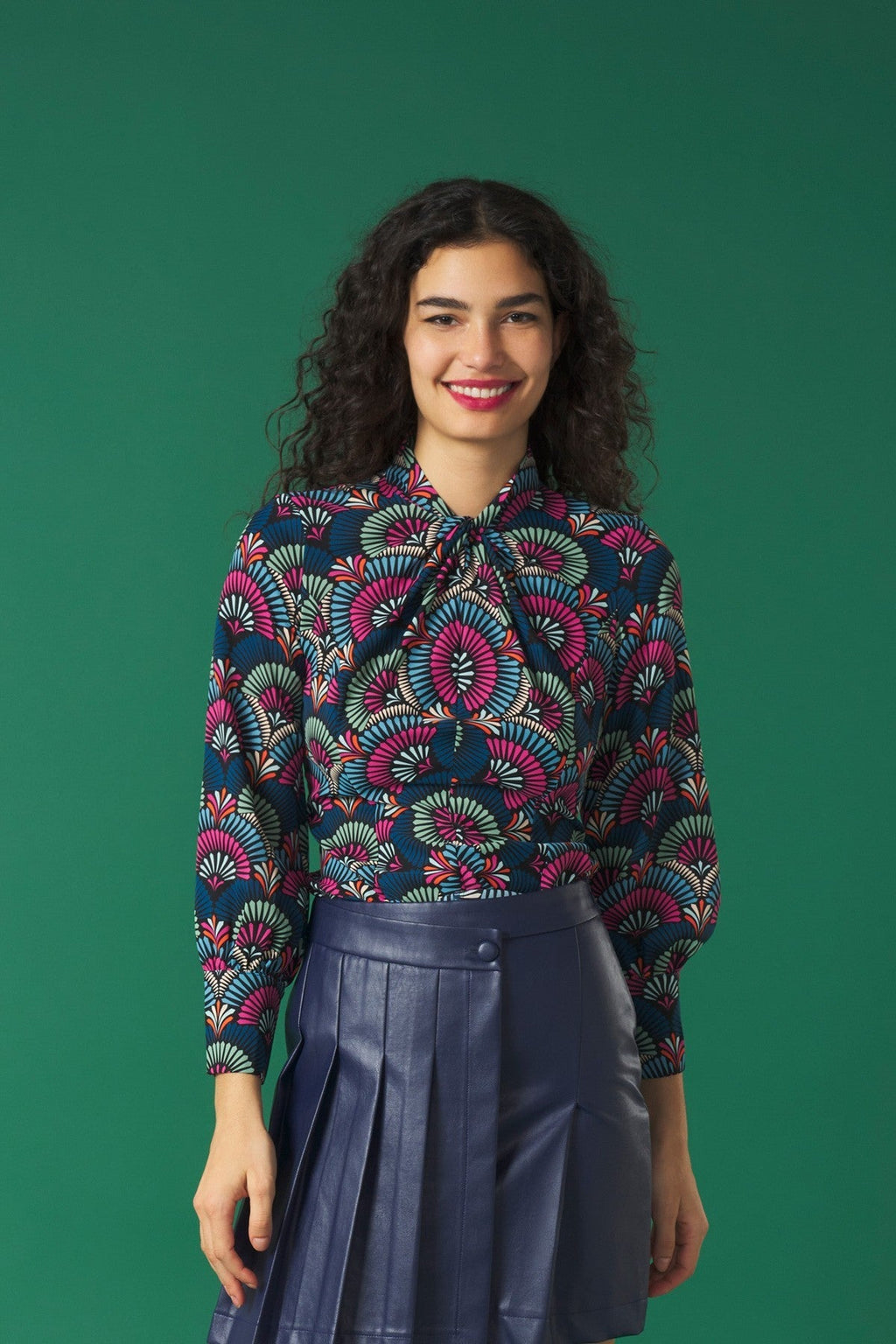 Turtleneck top with long sleeves.  Front knot detail.  Back zip fastening.