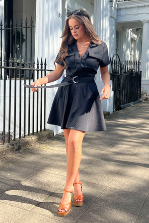 Equipped with belt detail, pockets, short sleeve, and skater skirt, this dress is perfect for making a bold fashion state