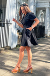 Equipped with belt detail, pockets, short sleeve, and skater skirt, this dress is perfect for making a bold fashion state