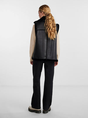 - Faux leather gilet - Asymmetric zip-up front - Oversized faux fur lapel - Sleeveless design with faux fur trim - Zipped chest pocket - Zipped side pockets