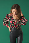 V-neck top with puff sleeves. Knot detail in the neck. Back zip fastening.