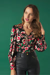 V-neck top with puff sleeves. Knot detail in the neck. Back zip fastening.