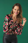 V-neck top with puff sleeves. Knot detail in the neck. Back zip fastening.