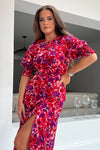 The form-flattering style contours your curves and features 3/4 sleeves with an elasticated cuff creating a subtle puff styling, and thigh high split for a gorgeous twist on a staple dress