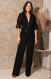 Handcrafted floral embellishments cover the sleeve, bust and leg, with flutter sleeves and plunge neckline creating a beautiful silhouette. The trouser is cut in a flattering wide leg finish, ending at floor length, and hidden hook and eye detail on the neckline allows for the plunge to be adjusted as desired
