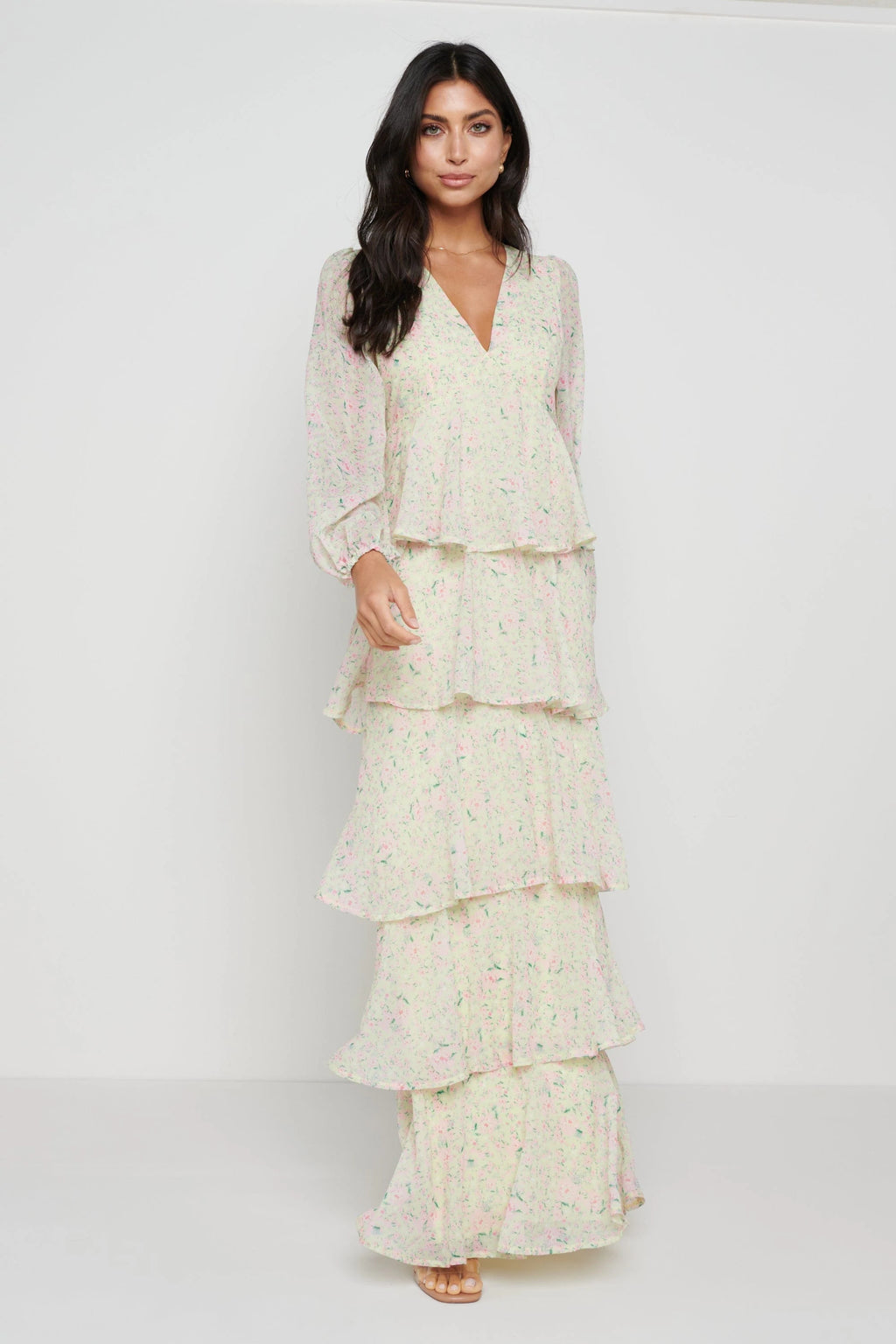 •Lightweight chiffon (100% polyester) •Plunge V-neckline •Ruffle tiered skirt •Balloon sleeves