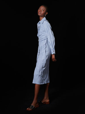 They're all waiting to see what you'll do next; you're slowly gaining more control. You've learned a lot from defeat. Now it's your time to defeat in this fitted shirt dress, and this light blue crinkle fabric is victorious. The pleated waist and front hem split detailing is the real threat.  Product details: Fitted shirt dress in a crinkle effect fabric. Detailed with pleating at the waist and a front hem split.    Size & Fit: Omoh is 5'10" and wears a size S (UK 8) Composition: Main: 100% Polyester