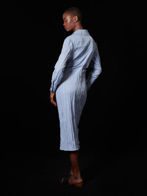 They're all waiting to see what you'll do next; you're slowly gaining more control. You've learned a lot from defeat. Now it's your time to defeat in this fitted shirt dress, and this light blue crinkle fabric is victorious. The pleated waist and front hem split detailing is the real threat.  Product details: Fitted shirt dress in a crinkle effect fabric. Detailed with pleating at the waist and a front hem split.    Size & Fit: Omoh is 5'10" and wears a size S (UK 8) Composition: Main: 100% Polyester