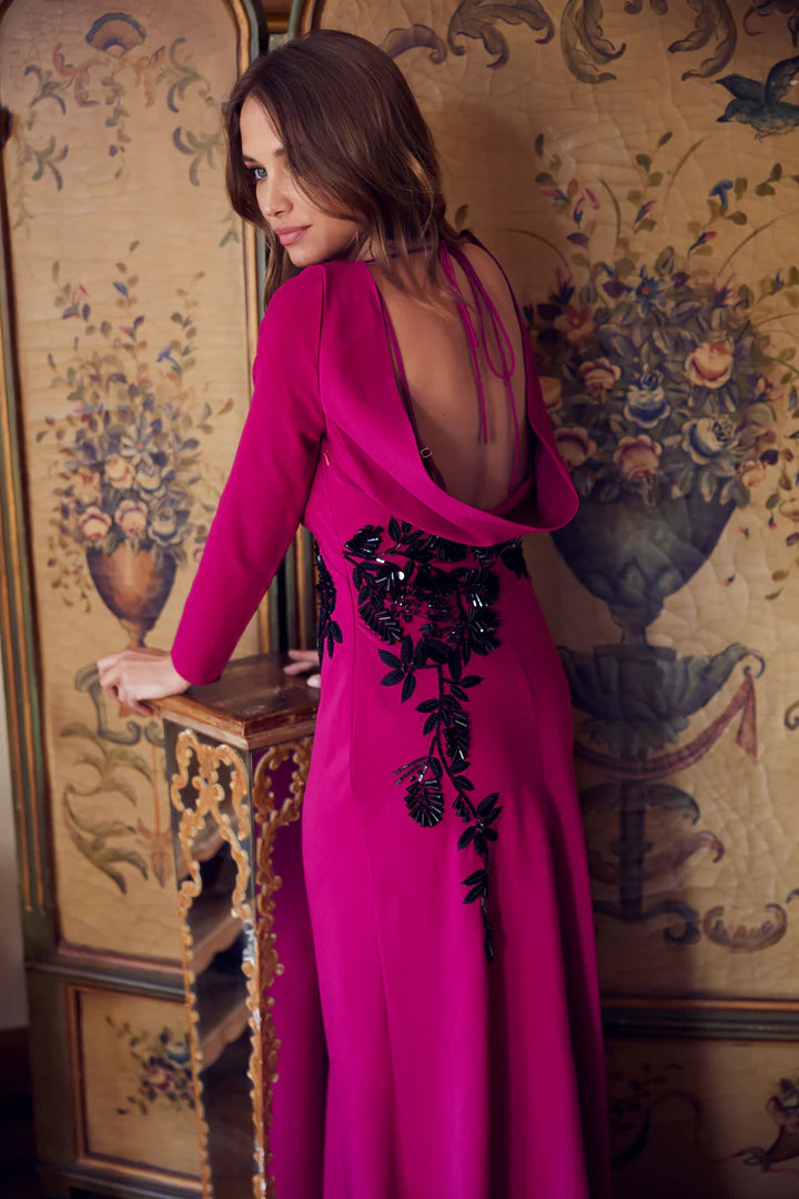 Featuring an open cowl back with tie detail, the maxi skirt hugs the figure and flows down to the floor to create a stunning silhouette. Black embellished florals stand-out against the deep berry purple base for a final touch of glamour to make you feel event-ready and fabulous.
