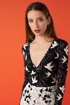 V-neck bodysuit with long sleeves and shoulder pads. Gathered detail on the front.  Model is 180 cm and wears size S.