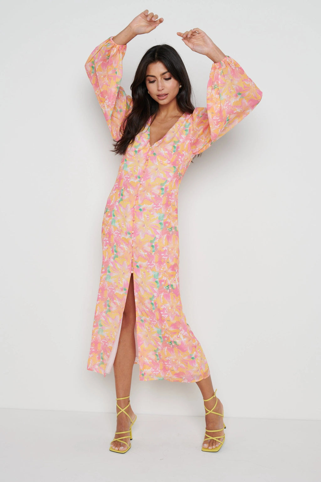 •Lightweight chiffon (100% polyester) •Balloon sleeve •middle slit •fabric covered button detailing •Lining in body •Elastic in sleeve head  Lygia is 5'9" and wears a size 8