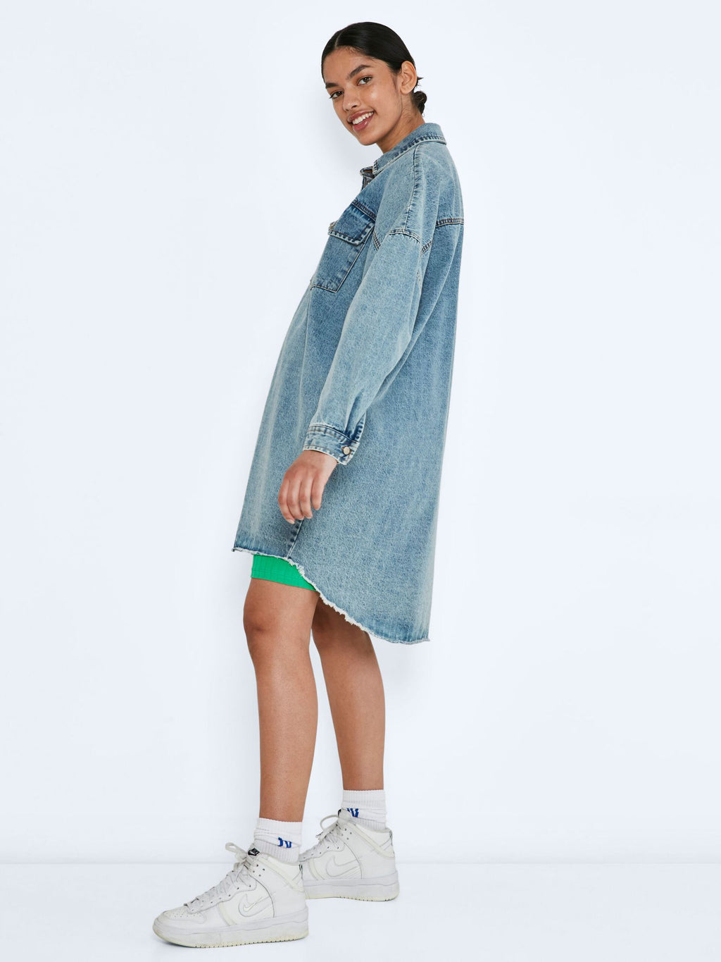Noisy May Long denim shirt jacket - Non-stretchy cotton material  - Oversize fit  - Pointed collar  - Long sleeved  - Dropped shoulders  - Button fastenings through front  - Front flap pockets with button fastening  - Curved hemline with raw edges  - Button fastening at cuffs