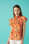 Round neck sleeveless top with honeycomb effect elastication. Ruffle detail on the shoulders.