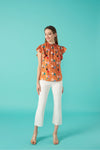 Round neck sleeveless top with honeycomb effect elastication. Ruffle detail on the shoulders.