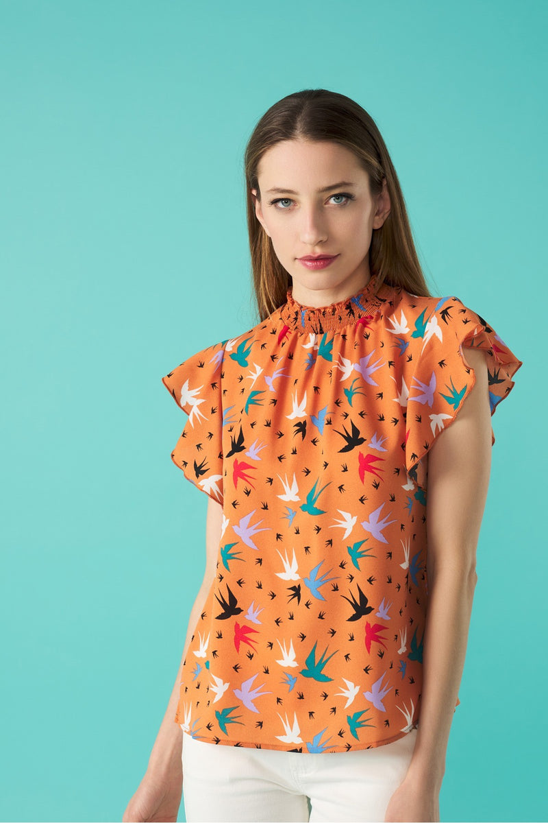 Round neck sleeveless top with honeycomb effect elastication. Ruffle detail on the shoulders.