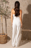 From our Spring 23 Bridal collection, this soft ivory jumpsuit is perfect for any bridal occasion, from hen do to the big day itself. The sleek, fitted bodice and wide leg trousers complete this flattering silhouette. With an oversized embellished bow adorning the bust, this piece brings the party to any wedding occasion. 