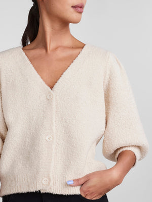 - V-neck  - Button-up front  - Half-length puff sleeves  - Ribbed trims  - Fluffy texture  - Regular fit