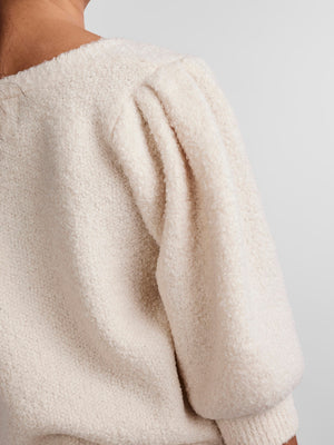 - V-neck  - Button-up front  - Half-length puff sleeves  - Ribbed trims  - Fluffy texture  - Regular fit