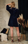 Delicate hand-embroidered autumnal florals decorate the velvet navy base along the shoulders and kimono style sleeves. With a plunging v-neckline, twist knot front and skater mini skirt, this is the perfect party piece or transitional autumn look. 